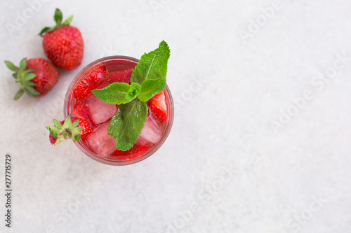 top view of the cooling summer cocktail with strawberries, ice and mint with free space for inscriptions