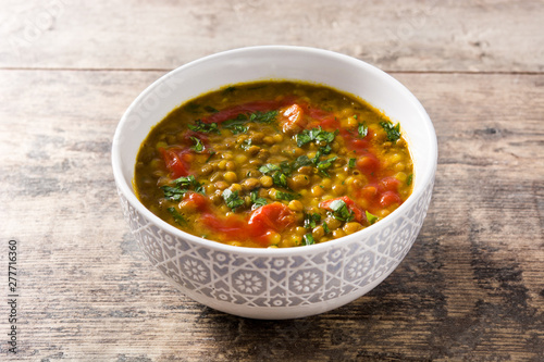 Indian lentil soup dal (dhal) in a bowl on wooden table