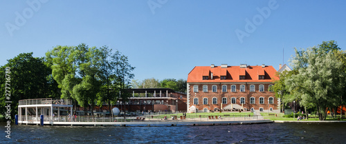 IN THE SUMMER ON SHORE OF LAKE - Ducal palace and church tower in a green resort town