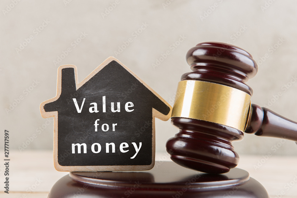 Real estate concept auction gavel and little house with inscription Value for money