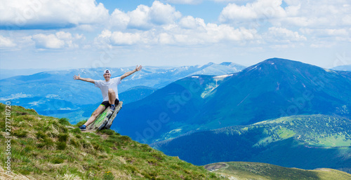 Man on top of a rocky mountain with beautiful view