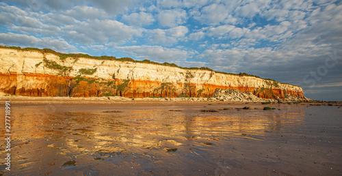 The famous red and white chalk cliffs of Hunstanton in Norfolk, England. photo