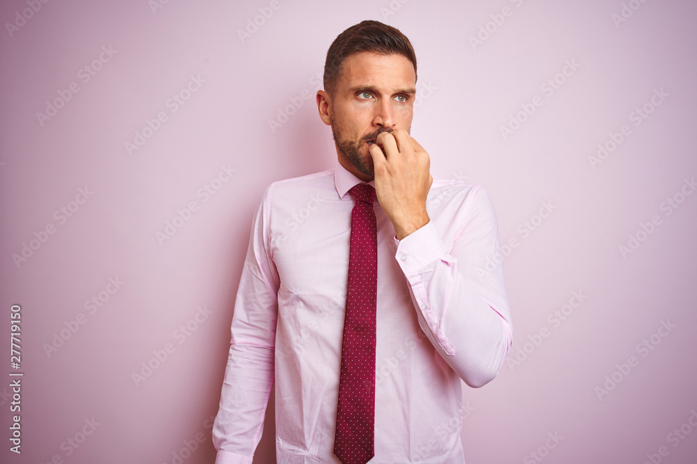 Business man wearing tie and elegant shirt over pink isolated background looking stressed and nervous with hands on mouth biting nails. Anxiety problem. Business man wearing tie and elegant shirt over pink isolated background looking stressed and nervous with hands on mouth biting nails. Anxiety problem.