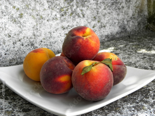 fresh red peaches on a plate