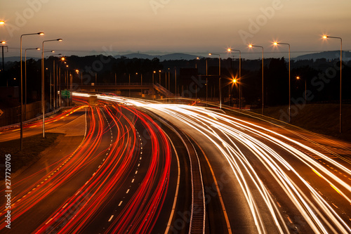 Traffic on a motorway at dusk. Blurred streaks of headlights and red tail lights. Dublin, Ireland.