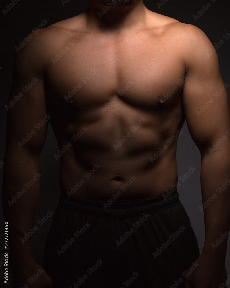 Perfect male torso with defined chest,abdominal and arm muscles. Fitness,  workout and training concept. Stock Photo