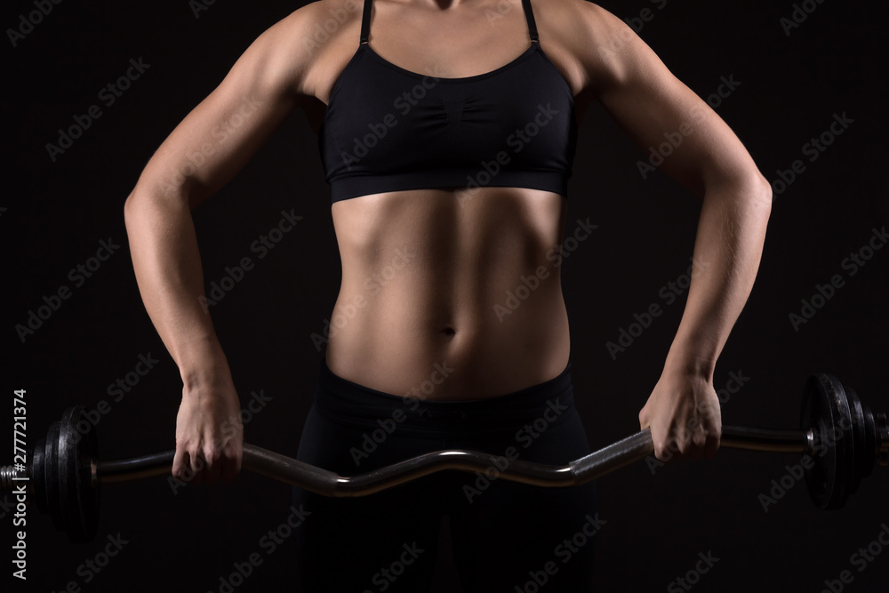 Woman with perfectly trained body is exercising on a barbell. Fitness, workout and training concept. Woman with perfectly trained body is exercising on a barbell. Fitness, workout and training concept.