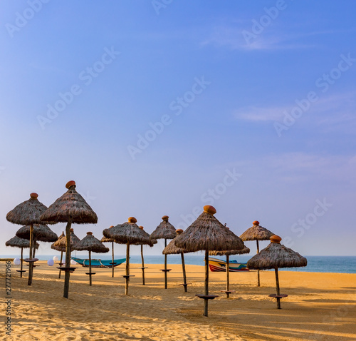 Straw umbrellas on the tropical sand beach of Mount Lavinia  Sri Lanka.