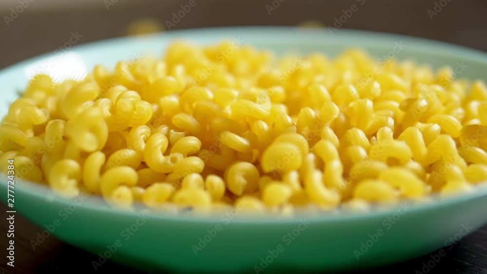 raw pasta. kawatappi pasta falls in a blue dish raw pasta. kawatappi pasta falls in a blue dish