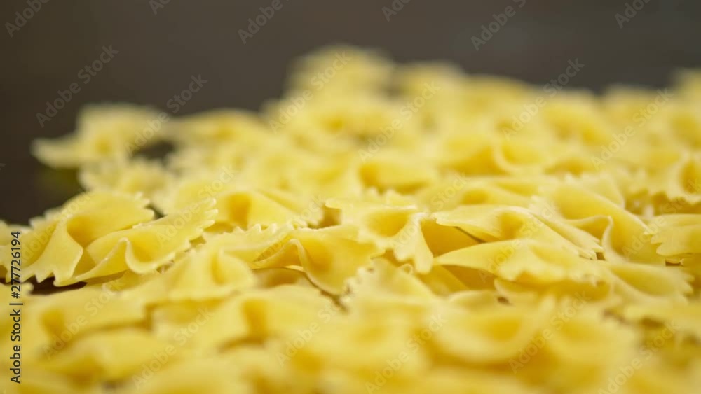 raw pasta. Farfalle closeup on wooden table raw pasta. Farfalle closeup on wooden table