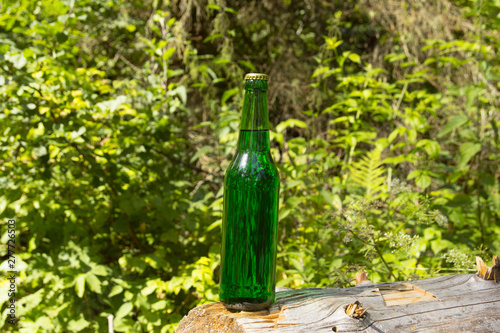Glass transparent green glass bottle. With a cork and a bottle opener.