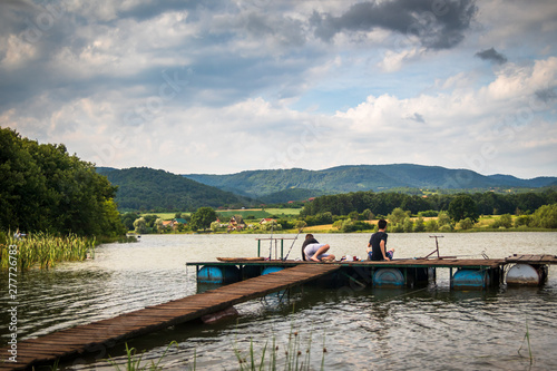 Fishermans on a primitive dock by the lake. Lake Gruza in the Serbia. photo