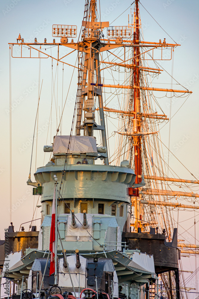 Battleship and sailboat in harbor Gdynia