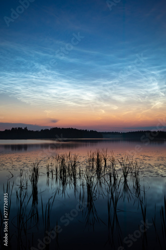 Night shining clouds over lake