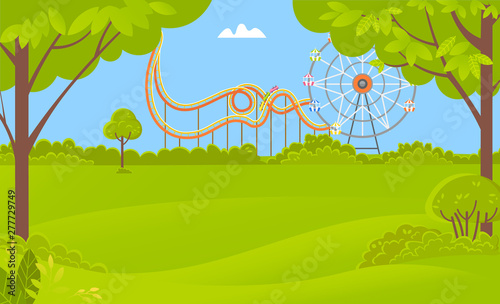 Ferris wheel amusement-park or fairground rides, green scenery with trees, bushes and grass, spring time. Landscape of forest or park and roller coaster
