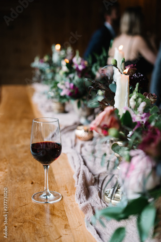 glass of wine at a decorated wooden table