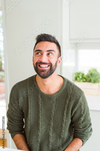 Handsome man smiling cheerful with a big smile on face showing teeth, positive and happy expression