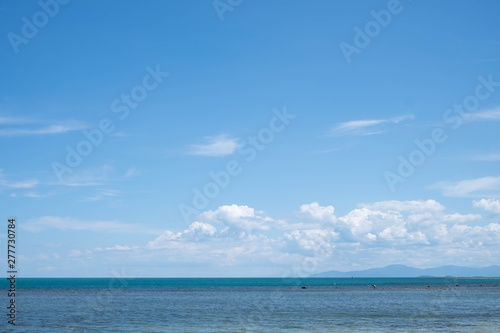 Blue Sky with White Clouds and Sea Background.