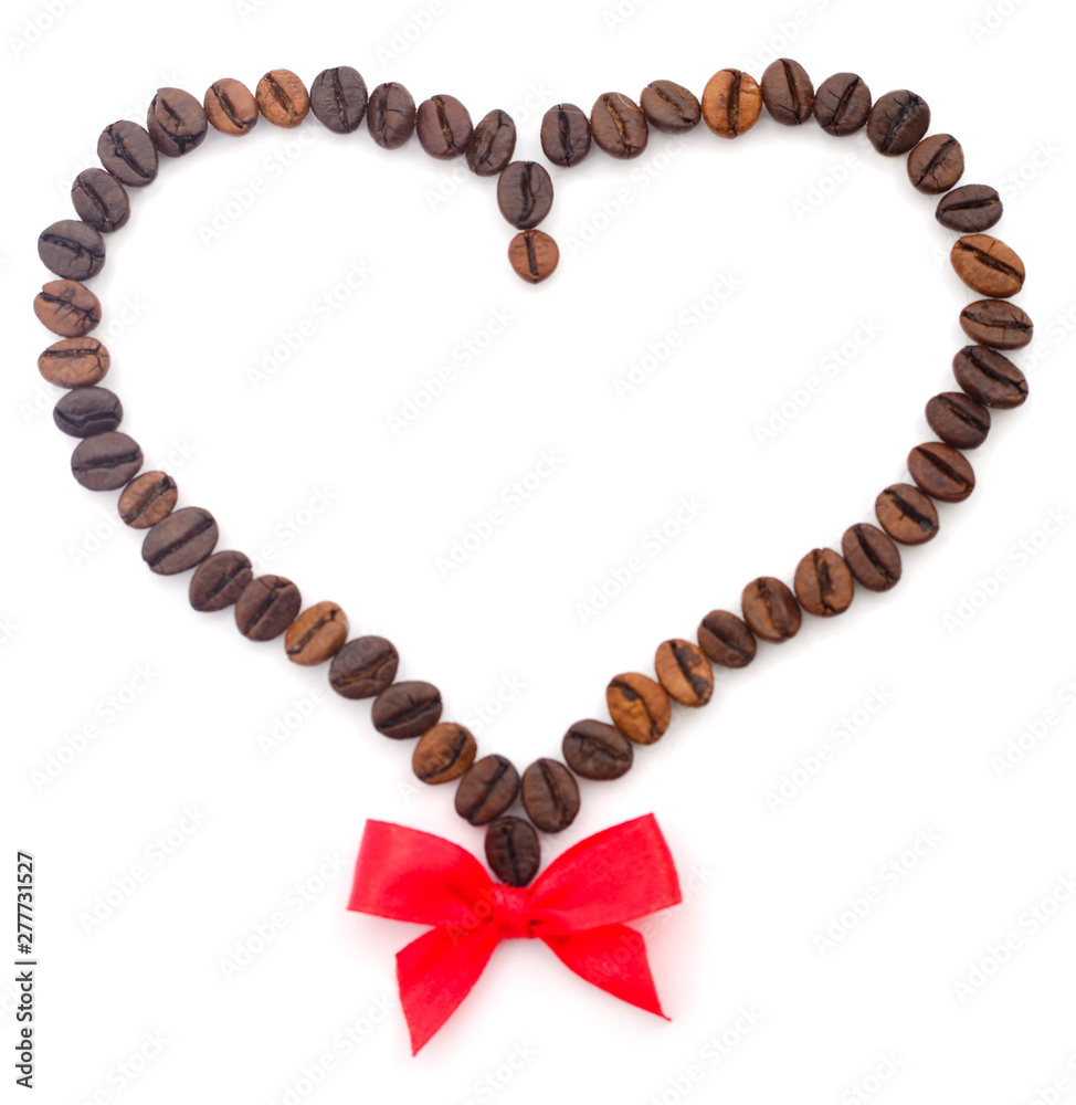 Coffee beans in the shape of a heart with a bow. Coffee beans in the shape of a heart with a bow.
