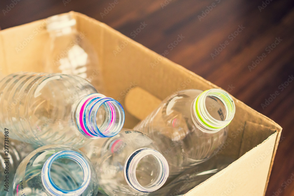 plastic bottles in recycling paper box reuse concept - obrazy, fototapety, plakaty 