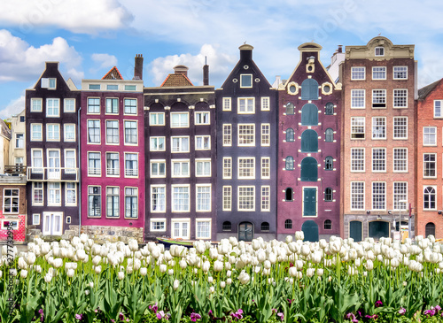 Amsterdam architecture at Damrak canal and spring tulips, Netherlands