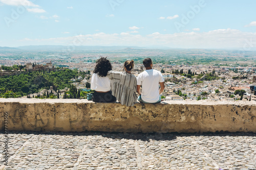 Group of friends doing tourism in Spain and contemplating the panoramic views of the Alhambra in Granada
