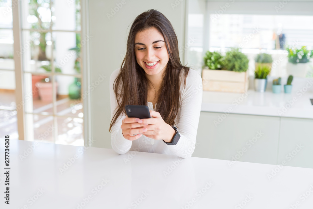 Young woman using smartphone, smiling happy texting and typing