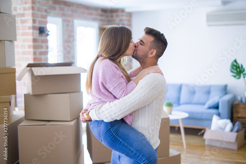 Young beautiful couple hugging in love celebrating very happy moving to new apartment © Krakenimages.com