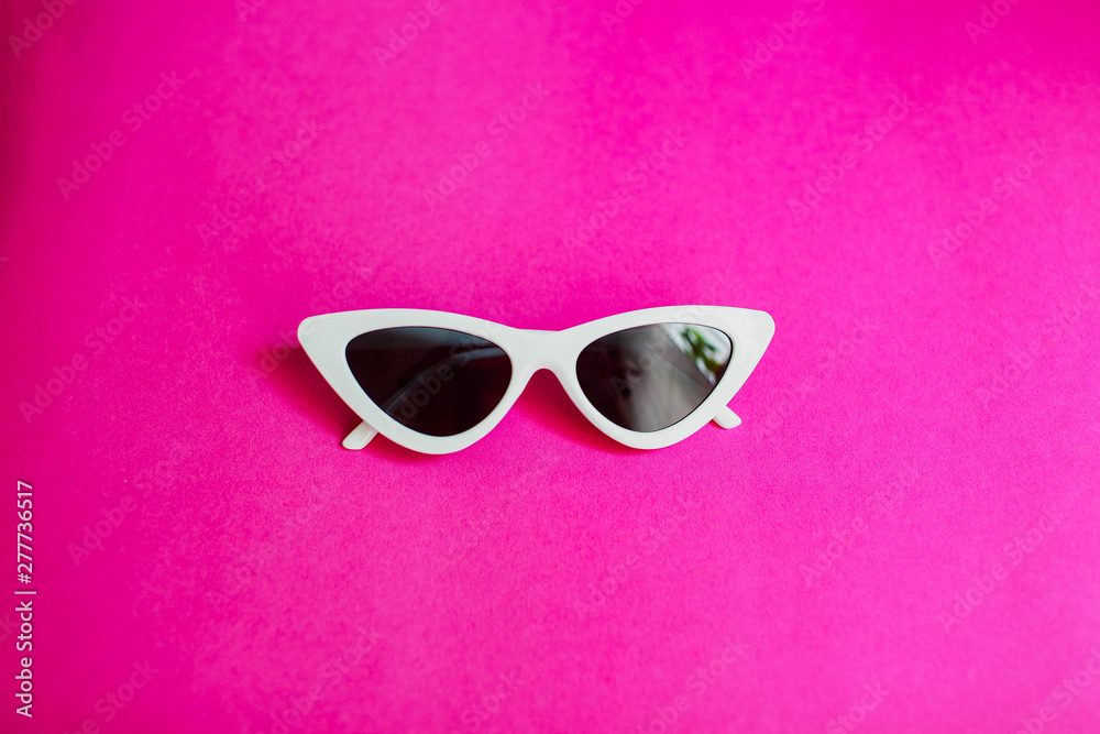 white women's sunglasses Glasses in the form of cat's eyes on a pink background white women's sunglasses Glasses in the form of cat's eyes on a pink background