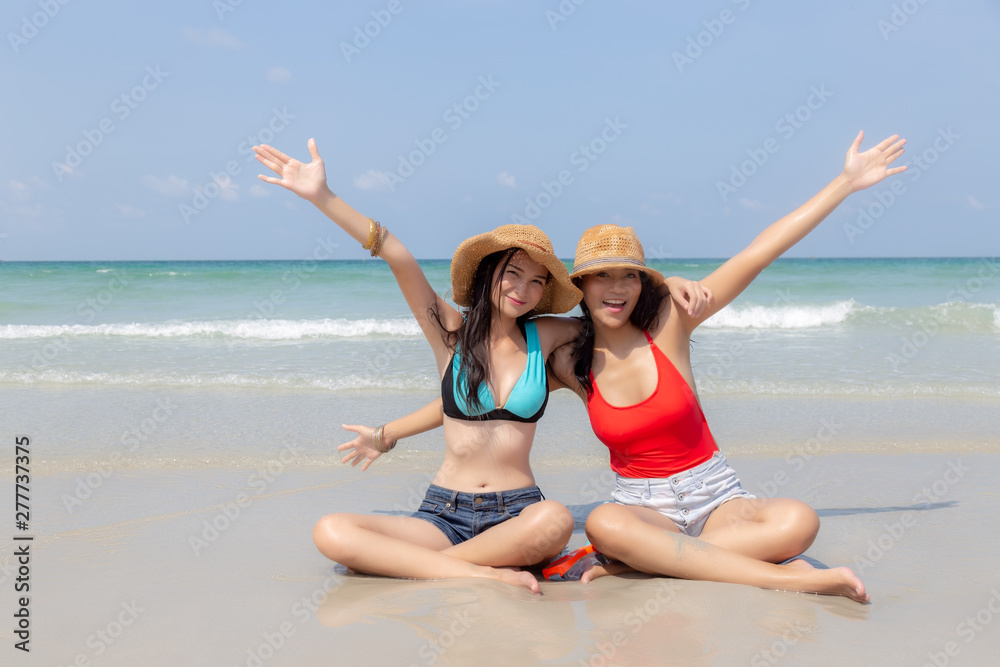 Beautiful young asian women feel happiness and raise up hands. Attractive beautiful traveler women get cheerful when their come to beautiful beach in summer season in vacation time. sea background Beautiful young asian women feel happiness and raise up hands. Attractive beautiful traveler women get cheerful when their come to beautiful beach in summer season in vacation time. sea background