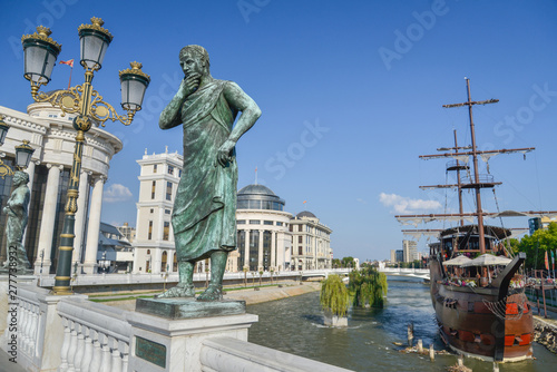 Skopje,thinking philosopher statue and lamps across the bridge in front of Archaeological Museum of Macedonia. photo