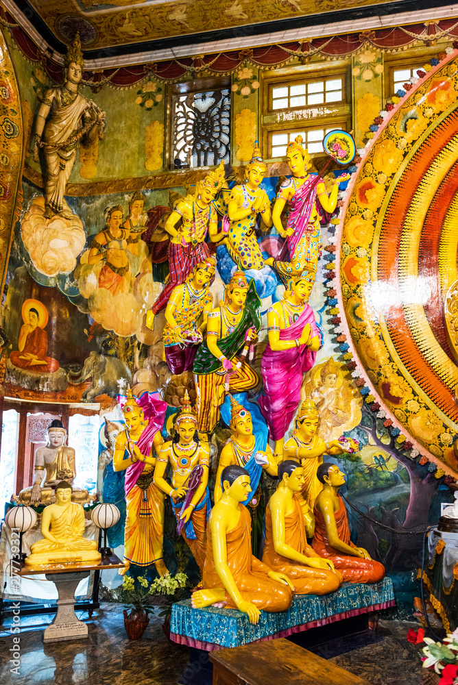 Group of statues in the temple of Gangaramaya, Colombo, Sri Lanka. Vertical.