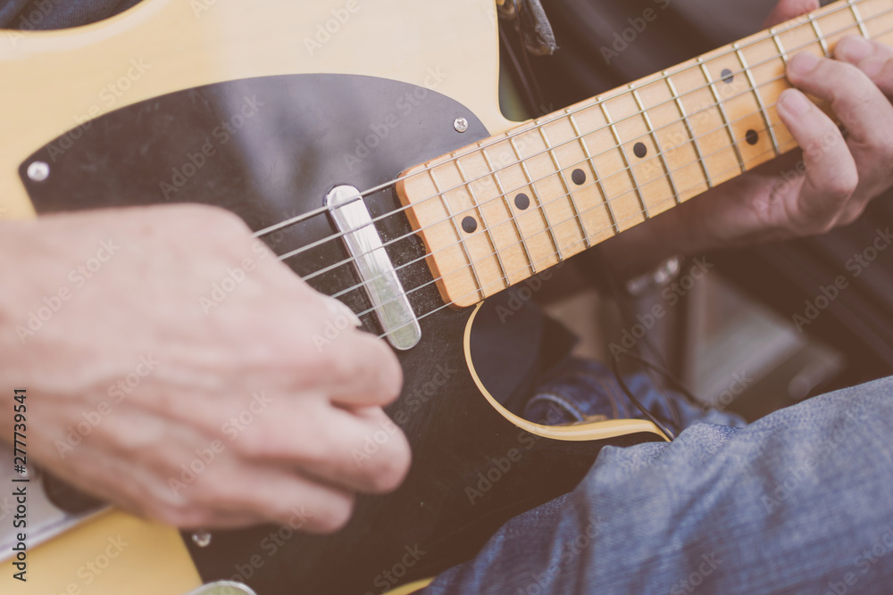 Fototapeta premium An older male musician playing guitar on a New York City Street