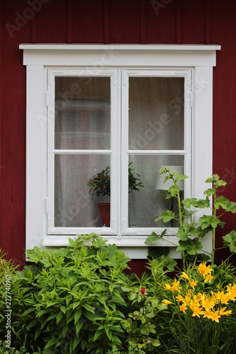 Window in an old Swedish house. Vintage window in the red house © Simon