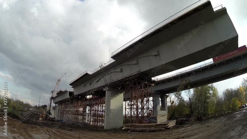 Under construction span of an automobile bridge over a river, freeway, viaduct Under construction span of an automobile bridge over a river, freeway, viaduct
