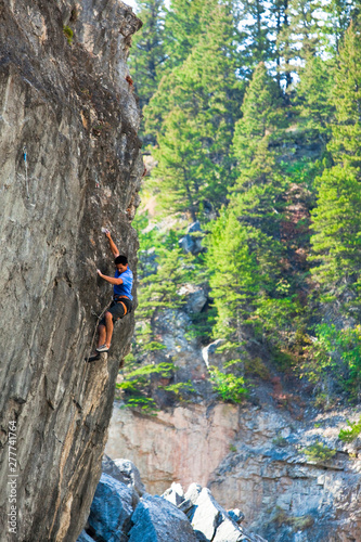 A climber makes magic on Monsters of the Deep (5.13c) at Natural Bridges State Park. photo