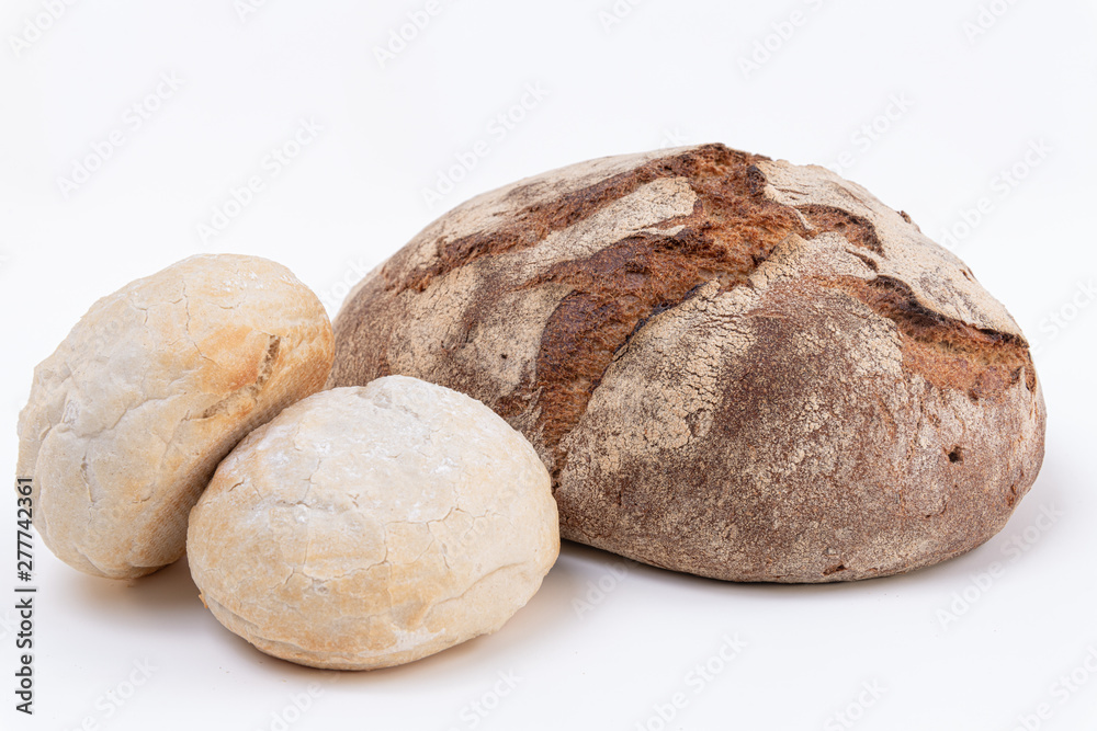 Delicious freshly rye dark bread and two white bread pieces on White background Delicious freshly rye dark bread and two white bread pieces on White background