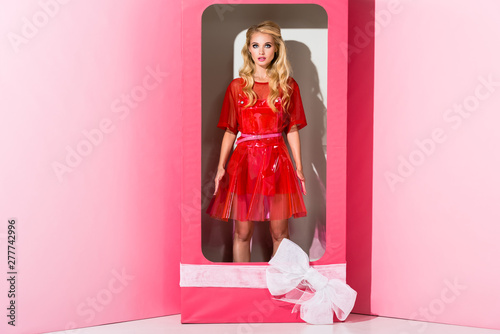 beautiful girl on pink in decorative box, doll concept photo