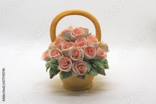 bouquet of roses in a basket isolated on white