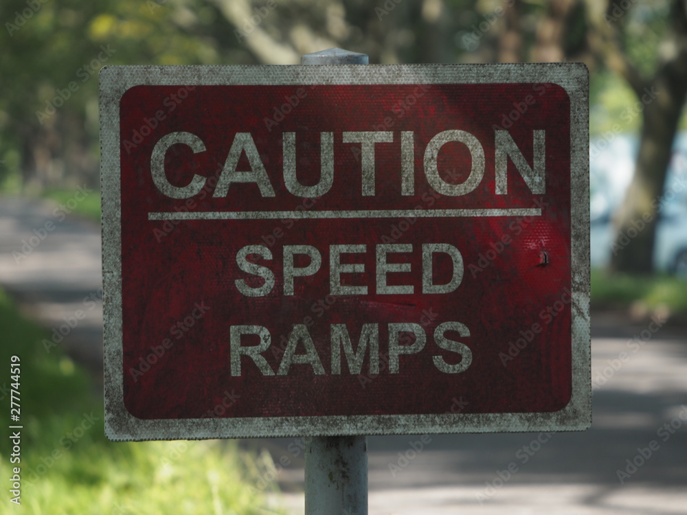 A speed ramps sign besides a road. 