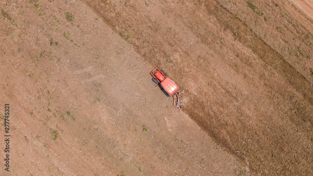 Top view of agricultural tractor vehicles working at field
