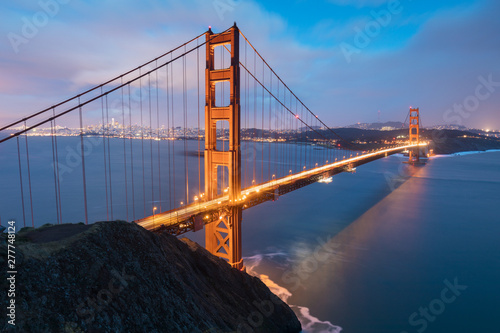 Classic panoramic view of famous Golden Gate Bridge in beautiful evening light on a dusk with blue sky and clouds in summer or autumn, San Francisco, California, USA