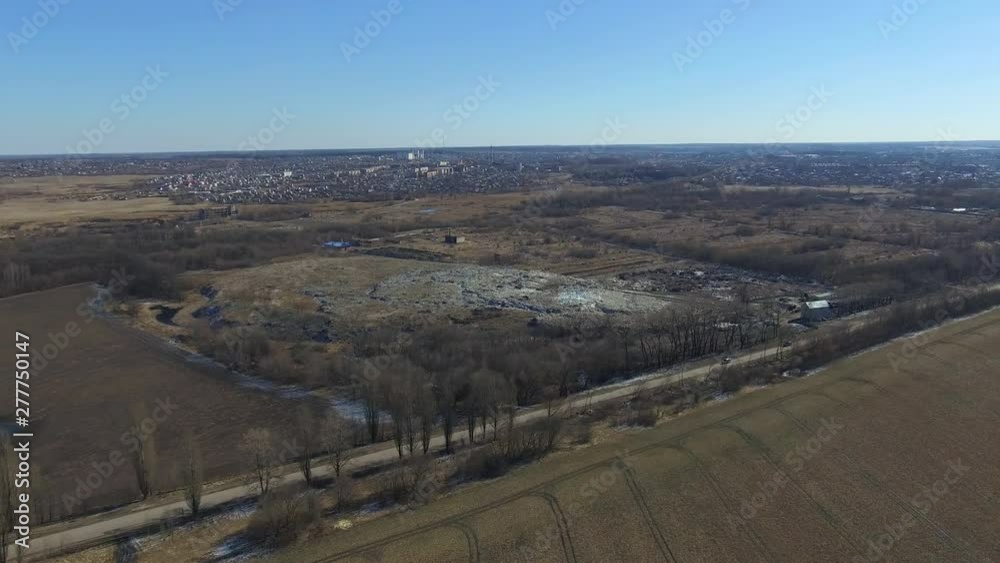 Domestic city waste dump and cars driving on the road highway. Pollution of nature and environment of Earth. Aerial survey from air, flight of drone Domestic city waste dump and cars driving on the road highway. Pollution of nature and environment of Earth. Aerial survey from air, flight of drone