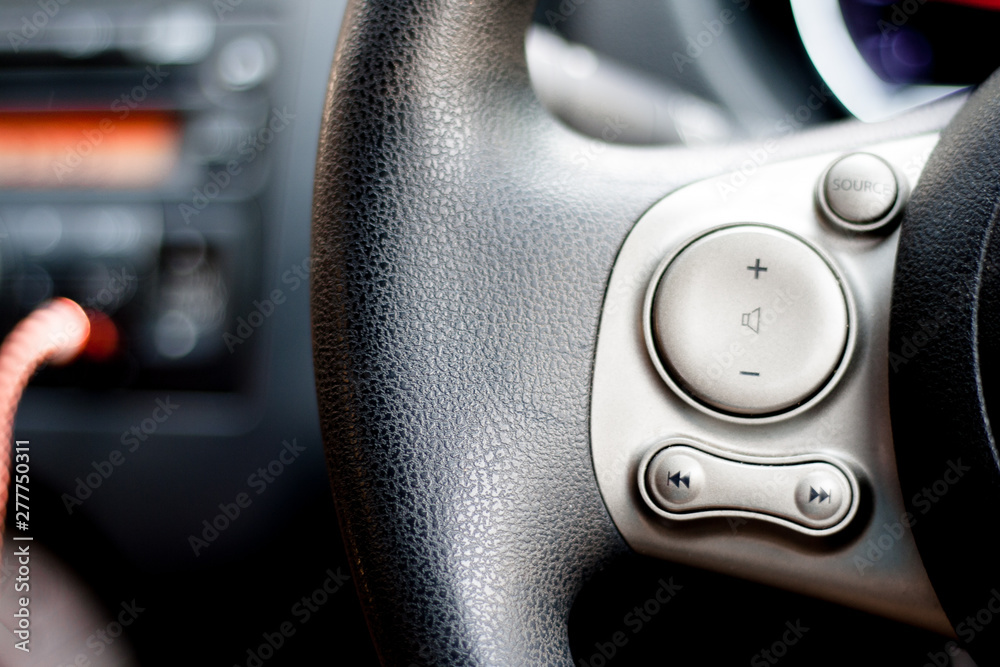 Modern car dashboard. The past of dashboard on steering wheel. Closeup interior modern car. Audio control button on the steering wheel inside the car.