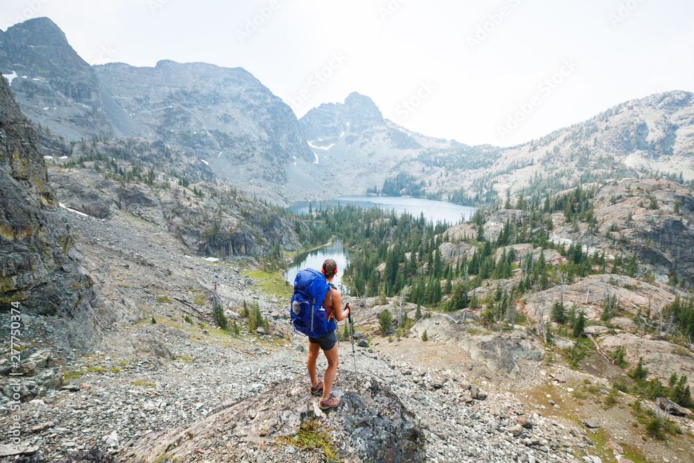 Rear view of hiker looking at Sheep Lake while standing on cliff Rear view of hiker looking at Sheep Lake while standing on cliff