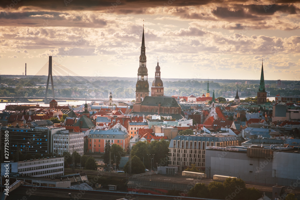 View of Riga, the capital of Latvia at sunset, from a height on a sunny summer day, the river and the city