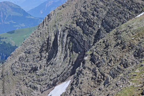 Rock folded into syncline in alpine swiss mountains. S-Fold found at steep mountain side. photo
