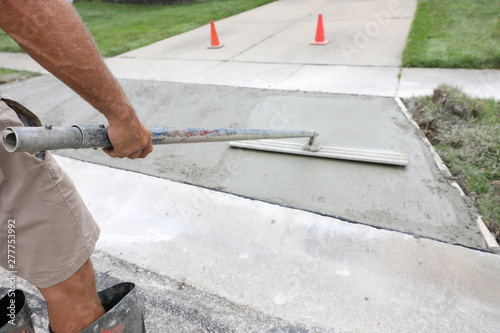 concrete work is being performed at a home in a urban neighborhood