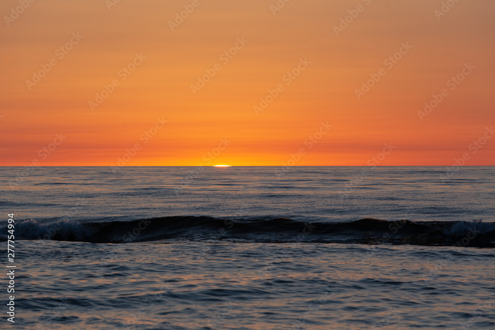 Baltic sea at sunset with golden sky landscape