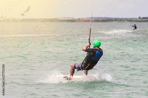 Kitesurfing Kiteboarding action photos man among waves quickly goes. Copy space